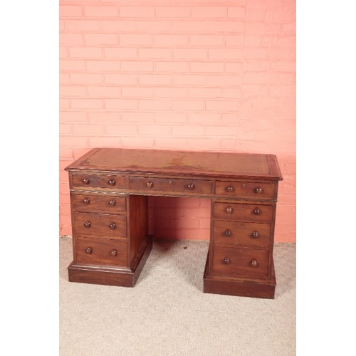 263 - A VICTORIAN MAHOGANY PEDESTAL DESK

the top inset with a gilt tooled leather writing surface, over n... 