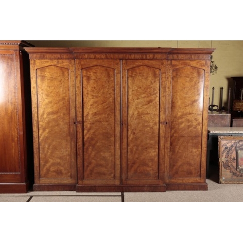 275 - A VICTORIAN MAHOGANY BREAKFRONT TRIPLE WARDROBE

the central cupboard opening to slides and deep dra... 