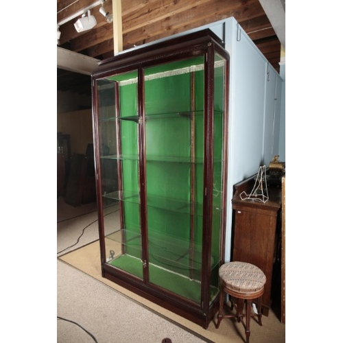 279 - AN EDWARDIAN MAHOGANY SHOP'S DISPLAY CABINET

with glazed doors opening to shelves, gilt metal pater... 