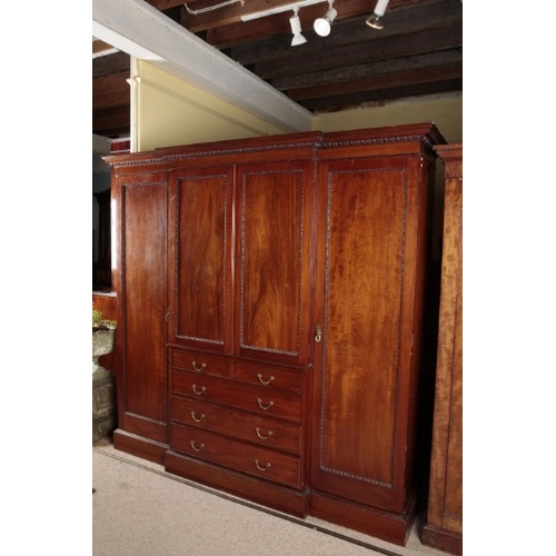 284 - A GEORGE III STYLE MAHOGANY TRIPLE WARDROBE

the moulded cornice over egg and dart moulded cupboard ... 