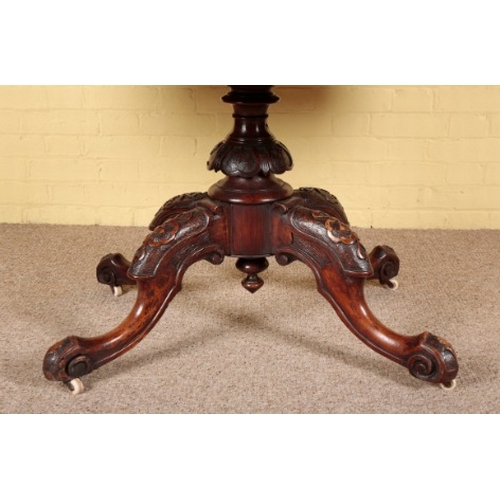 308 - A VICTORIAN BURR WALNUT CENTRE TABLE

the quarter veneered oval tilt-top on a heavily carved quadrup... 