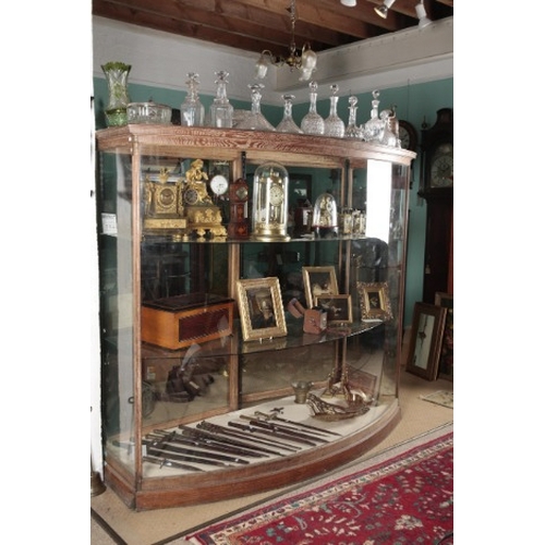 319 - A LIMED OAK BOW FRONT SHOP DISPLAY CABINET

late 19th/early 20th century, two doors to the back open... 