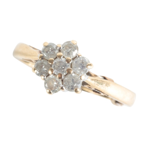 32 - A DIAMOND FLOWERHEAD RING

the face set with seven stones, each approx. 0.02ct, in an 18ct gold sett... 