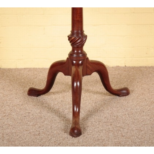 322 - A GEORGE II MAHOGANY TRIPOD TABLE

the circular tilt-top on a baluster-turned stem with cabriole leg... 