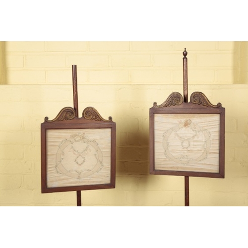 343 - A PAIR OF REGENCY MAHOGANY AND GILT METAL MOUNTED POLE SCREENS

each with a silkwork panel on a turn... 