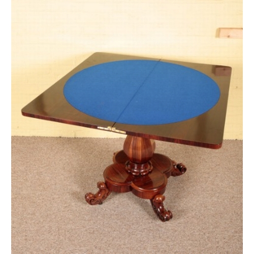 364 - A WILLIAM IV ROSEWOOD CARD TABLE

the hinged lid opening to a blue baize-lined interior, on a facete... 