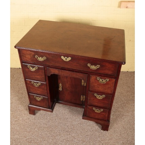 378 - A GEORGE II MAHOGANY KNEEHOLE DESK

circa 1750, the top with a moulded edge over an arrangement of e... 