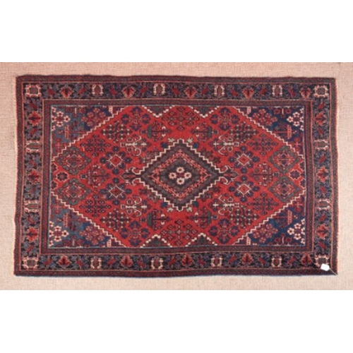 394 - A PERSIAN RUG

of madder ground with lozenge to the centre and scattered geometric motifs in blues, ... 