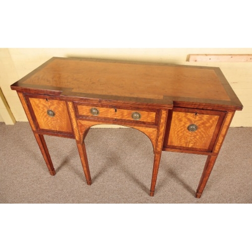 413 - A GEORGE III SATINWOOD BREAKFRONT SIDEBOARD

late 18th century, the crossbanded top over a single cu... 