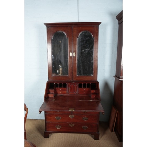 428 - A GEORGE II RED WALNUT BUREAU BOOKCASE

the upper section with a moulded cornice over mirrored cupbo... 