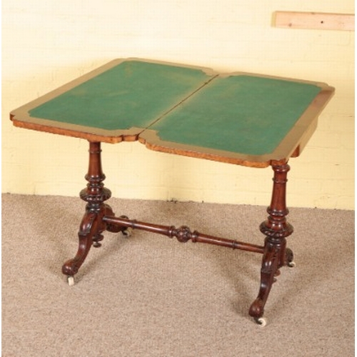 471 - A VICTORIAN BURR WALNUT CARD TABLE

the hinged and rotating top opening to a baize-lined interior, o... 