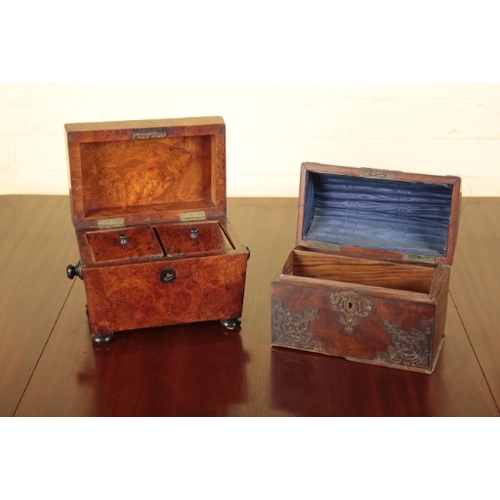 497 - A VICTORIAN BURR WOOD AND EBONY SARCOPHAGUS TEA CADDY

the hinged lid opening to an interior fitted ... 