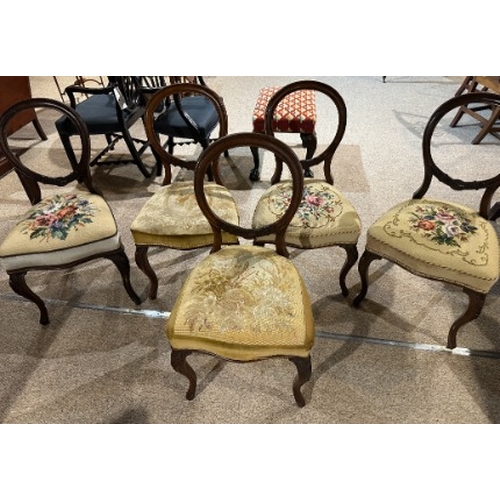 498 - A SET OF FIVE VICTORIAN WALNUT BALLOON BACK DINING CHAIRS

the backs carved with buckles, two seats ... 