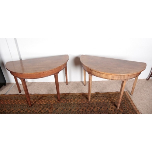 503 - A PAIR OF GEORGE III MAHOGANY DEMI-LUNE SIDE TABLES

on square tapered legs, 71cm high x 114cm wide ... 