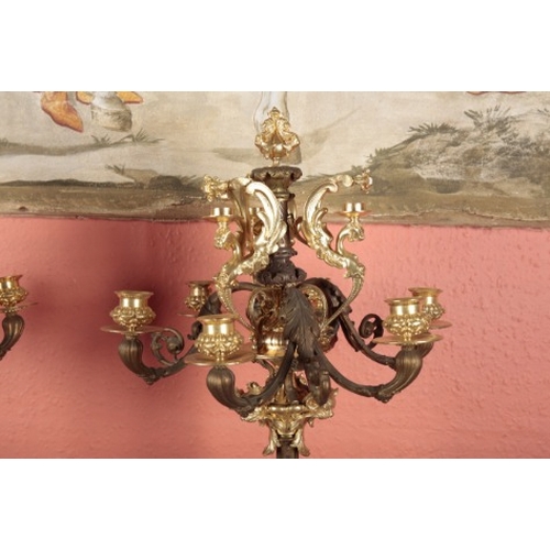 52 - AN IMPRESSIVE PAIR OF FRENCH BRONZE AND GILT METAL CANDELABRA

each with a tier of three lions head ... 