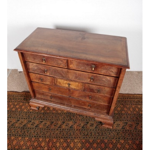 520 - A WALNUT AND PARQUETRY CHEST OF DRAWERS

18th century, the herringbone crossbanded top over an arran... 