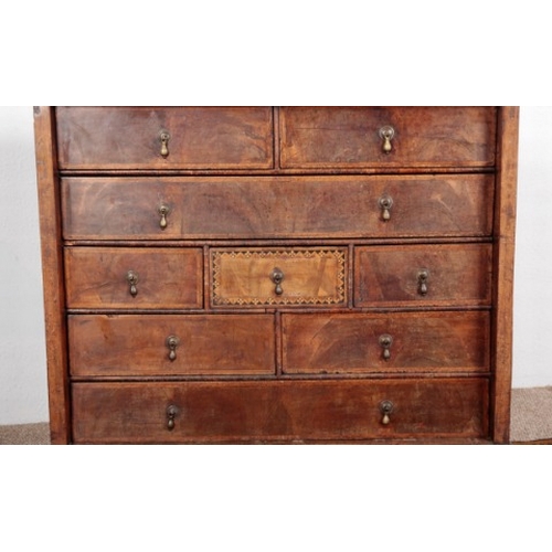 520 - A WALNUT AND PARQUETRY CHEST OF DRAWERS

18th century, the herringbone crossbanded top over an arran... 