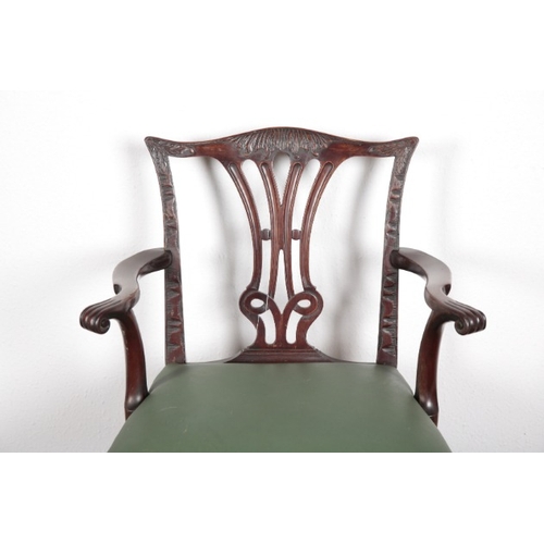 534 - A GEORGE III STYLE MAHOGANY ARMCHAIR

the shaped and carved cresting rail over a pierced back splat,... 