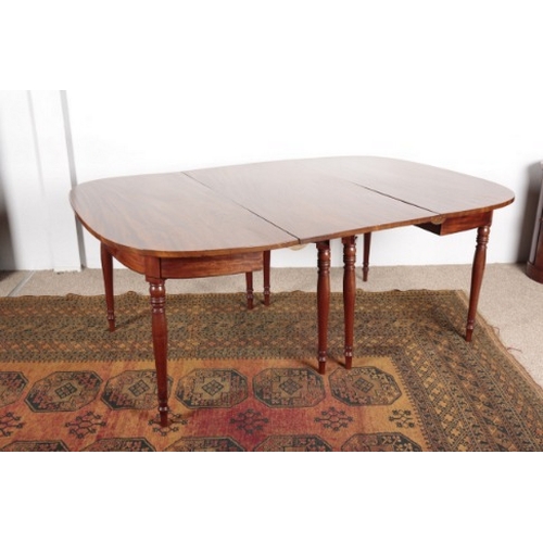 559 - A REGENCY MAHOGANY DINING TABLE

with two D-ends and a central leaf, on ring turned and tapered legs... 