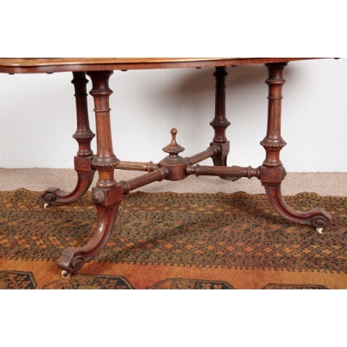 568 - A VICTORIAN WALNUT AND BURR WALNUT CENTRE TABLE

the shaped quarter veneered top on turned and flute... 