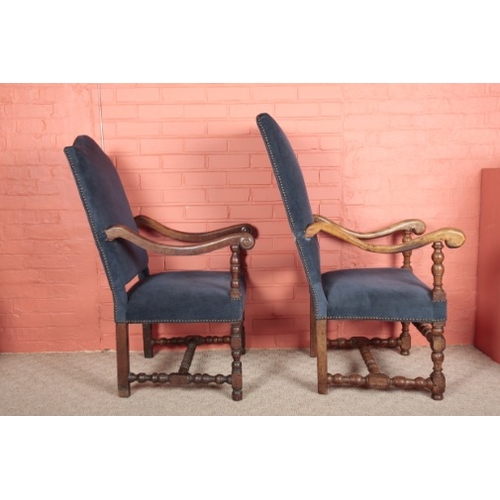 57 - A NEAR PAIR OF LOUIS XVI WALNUT FAUTEUILS

with blue velvet covers, on turned legs joined by turned ... 