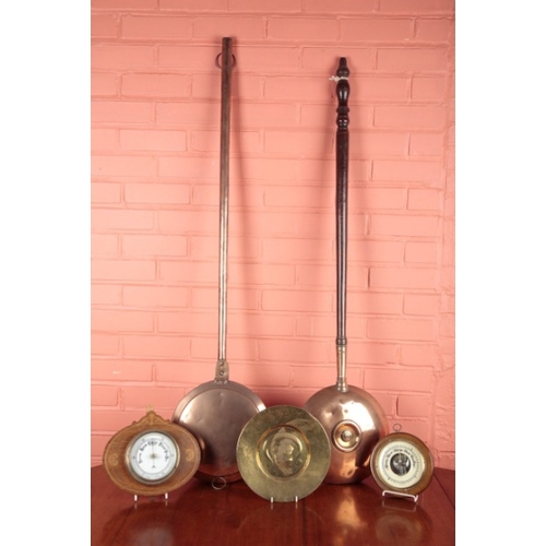 572 - TWO BRASS ANEROID BAROMETERS

the larger set within an inlaid oak frame, 23cm high x 27cm long; toge... 