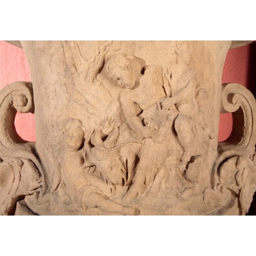 58 - A LARGE COMPOSITE STONE GARDEN URN

circa 1880, the body decorated in relief with putti and goats, w... 