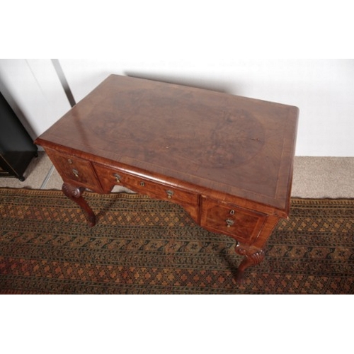 585 - A QUEEN ANNE STYLE WALNUT LOW BOY

19th century, the herringbone crossbanded top over three short dr... 