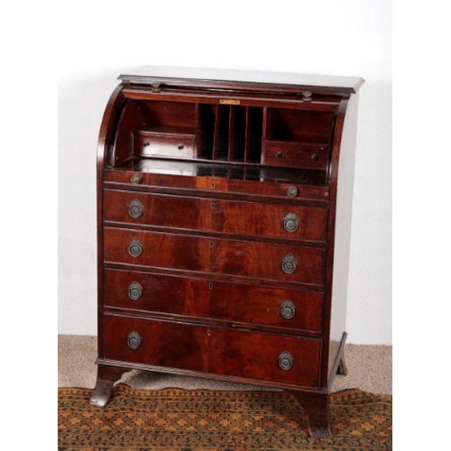 589 - AN EDWARDIAN MAHOGANY CYLINDER BUREAU

the lifting front opening to a leather inset writing surface,... 