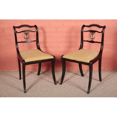 61 - A SET OF SIX REGENCY EBONISED DINING CHAIRS

the rope-twist top rails over a gilt metal mounted lyre... 