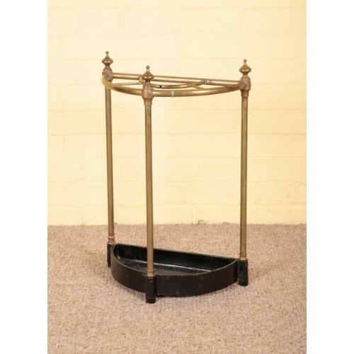 63 - A VICTORIAN BRASS AND CAST IRON STICK STAND

with turned finials and black painted drip tray, 58cm h... 