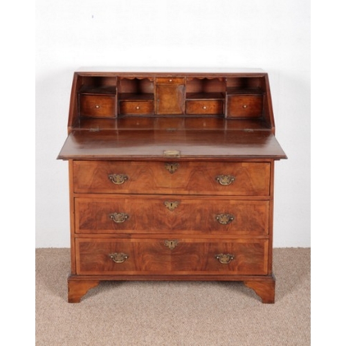 631 - A GEORGE II STYLE FIGURED WALNUT BUREAU

with four graduated drawers, on bracket feet, 101cm high x ... 