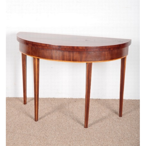 648 - A GEORGE III MAHOGANY DEMI-LUNE CARD TABLE

with satinwood inlay and chamfered legs, 74cm high x 105... 