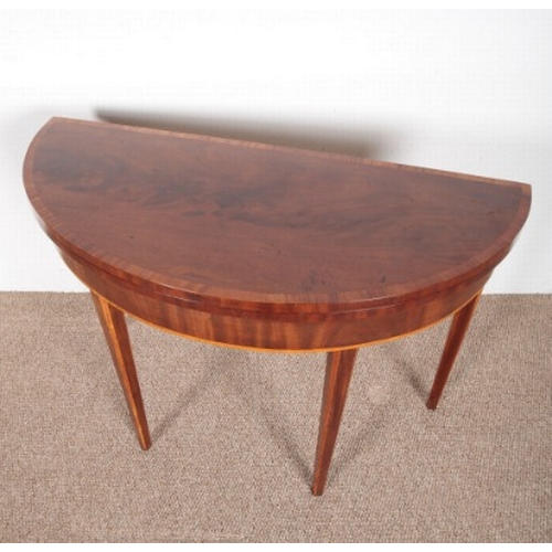 648 - A GEORGE III MAHOGANY DEMI-LUNE CARD TABLE

with satinwood inlay and chamfered legs, 74cm high x 105... 