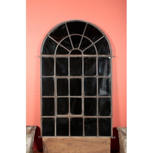 65 - AN ARCHITECTURAL CAST IRON GARDEN MIRROR

with arched top and thirty-one panes, a hinged four pane p... 