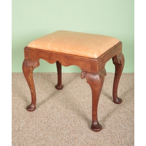 691 - A QUEEN ANNE STYLE OAK STOOL

probably early 20th century, the drop-in leather seat above cabriole l... 