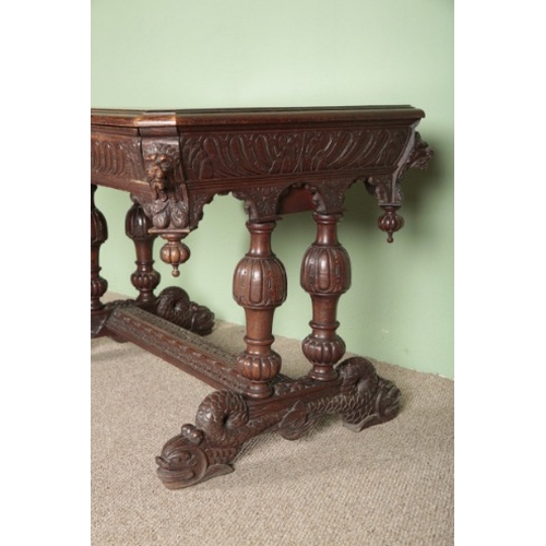 695 - A VICTORIAN GOTHIC OAK CENTRE TABLE

the single frieze drawer carved with a green man's head handle,... 