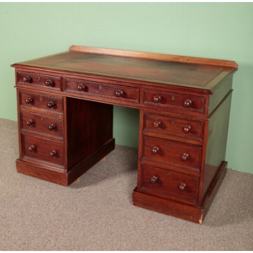 714 - A VICTORIAN MAHOGANY PEDESTAL DESK

the top inset with a gilt tooled leather writing surface, an arr... 