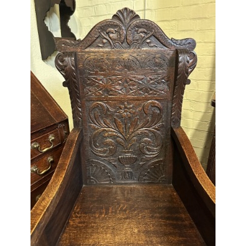 720 - A WAINSCOT OAK ARMCHAIR IN 17TH CENTURY STYLE

late 19th century, with scrolled top rail and elabora... 