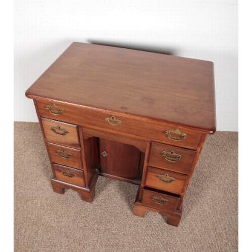 721 - A GEORGE III MAHOGANY KNEEHOLE DESK

mid 18th century, the rectangular top with a moulded edge over ... 