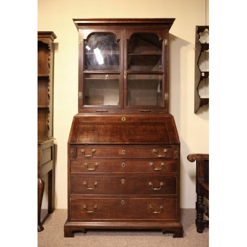 723 - A GEORGE III OAK BOOKCASE SECRETAIRE

with plain glazed front opening to two internal shelves, the f... 