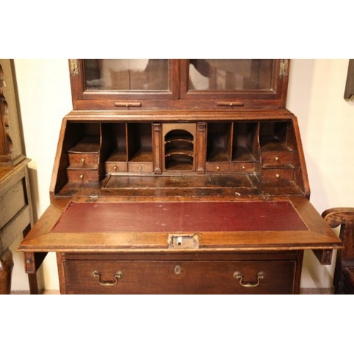 723 - A GEORGE III OAK BOOKCASE SECRETAIRE

with plain glazed front opening to two internal shelves, the f... 