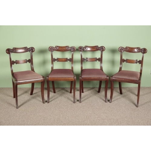 728 - A SET OF FOUR WILLIAM IV MAHOGANY DINING CHAIRS

with carved tablet backs and upholstered drop-in se... 