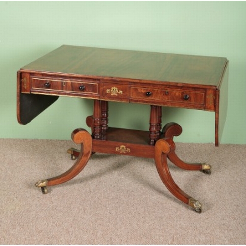 736 - A REGENCY ROSEWOOD SOFA TABLE

with two single drawers, brass inlaid top on twin shaped legs to bras... 