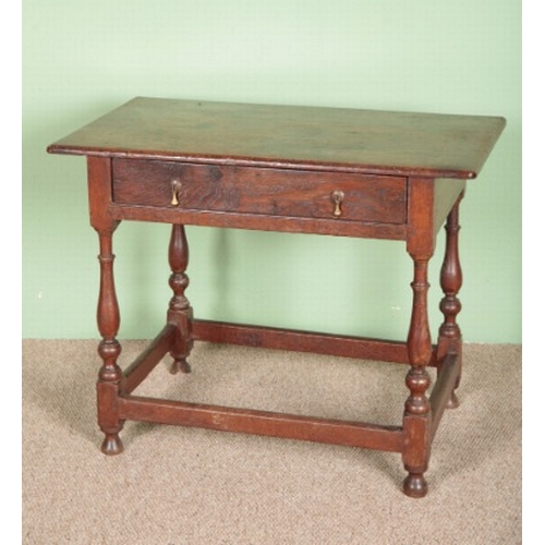 743 - AN OAK SIDE OR OCCASIONAL TABLE

18th century, a single drawer above turned supports and stretchers,... 