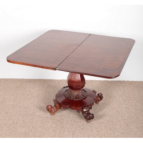 759 - A VICTORIAN MAHOGANY FOLD-OVER TEA TABLE

on a central pedestal base to turned legs on bun feet, 70c... 