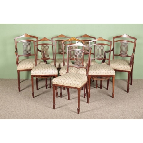 787 - A SET OF EIGHT EDWARDIAN MAHOGANY AND MARQUETRY DINING CHAIRS

the shaped cresting rails inlaid with... 