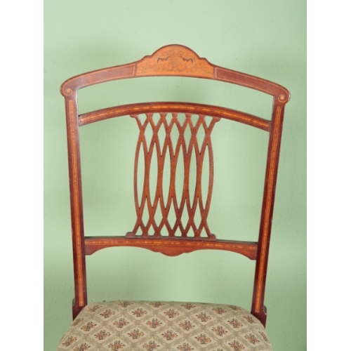 787 - A SET OF EIGHT EDWARDIAN MAHOGANY AND MARQUETRY DINING CHAIRS

the shaped cresting rails inlaid with... 