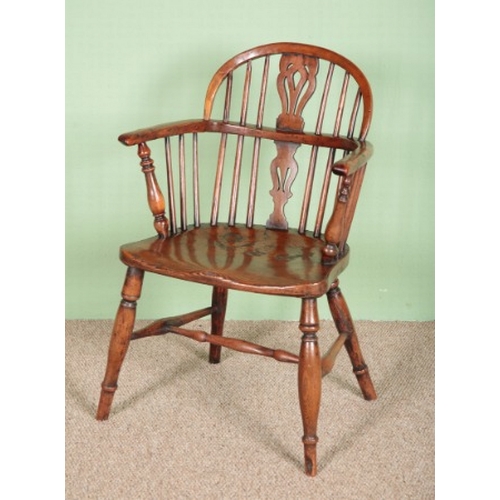 793 - A WINDSOR HOOP BACK ARMCHAIR OF SMALL PROPORTIONS

early 19th century, of yew and elm, with pierced ... 