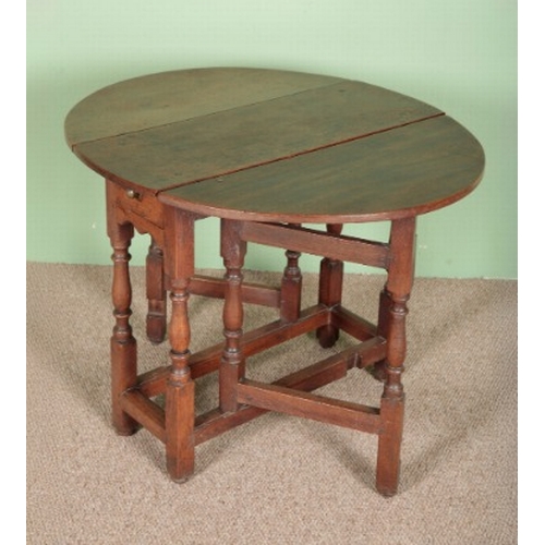 799 - AN OAK GATELEG TABLE

late 17th century, the oval top above a single frieze drawer, on turned legs j... 